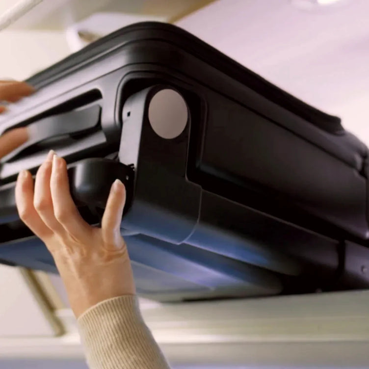 
Folded TernX stroller sliding into an overhead bin
