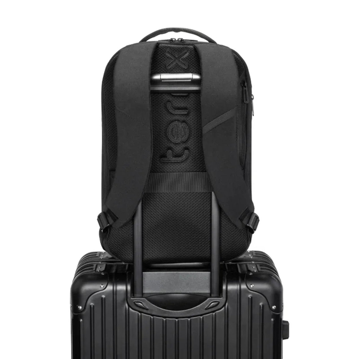 TernX diaper bag sliding onto a suitcase handle via the trolley luggage pass-through sleeve