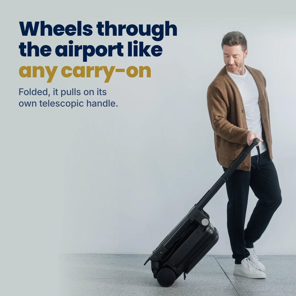 Wheeling the folded TernX through the airport on its telescopic handle