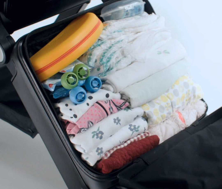 
Open TernX stroller packed with baby clothes and diapers
