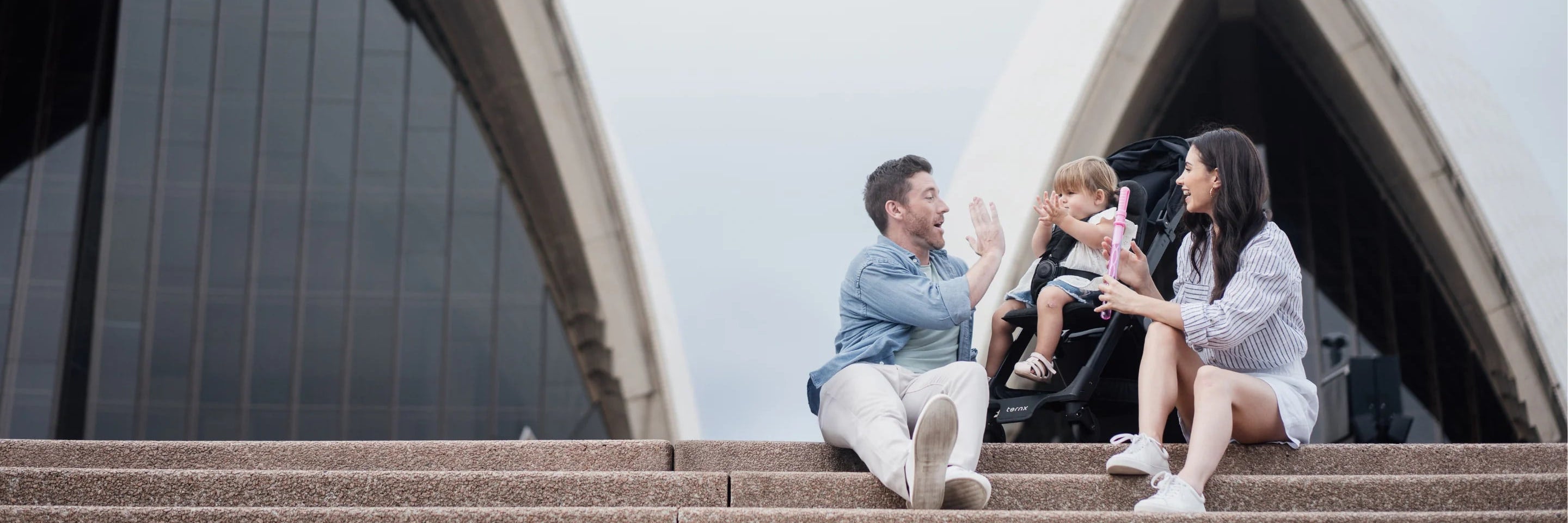 Family on the Sydney Opera House steps with a toddler in a TernX stroller