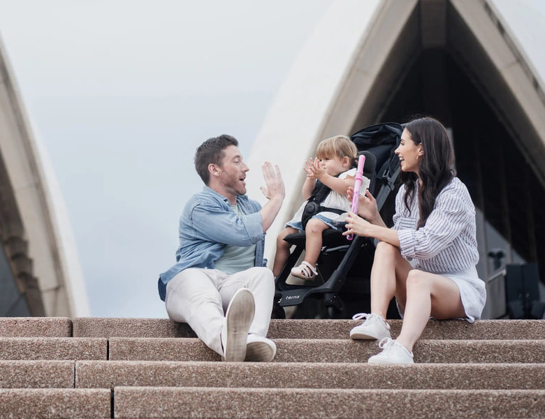 Family on the Sydney Opera House steps with a toddler in a TernX stroller